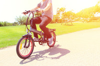 A man riding on electric bicycle in a park